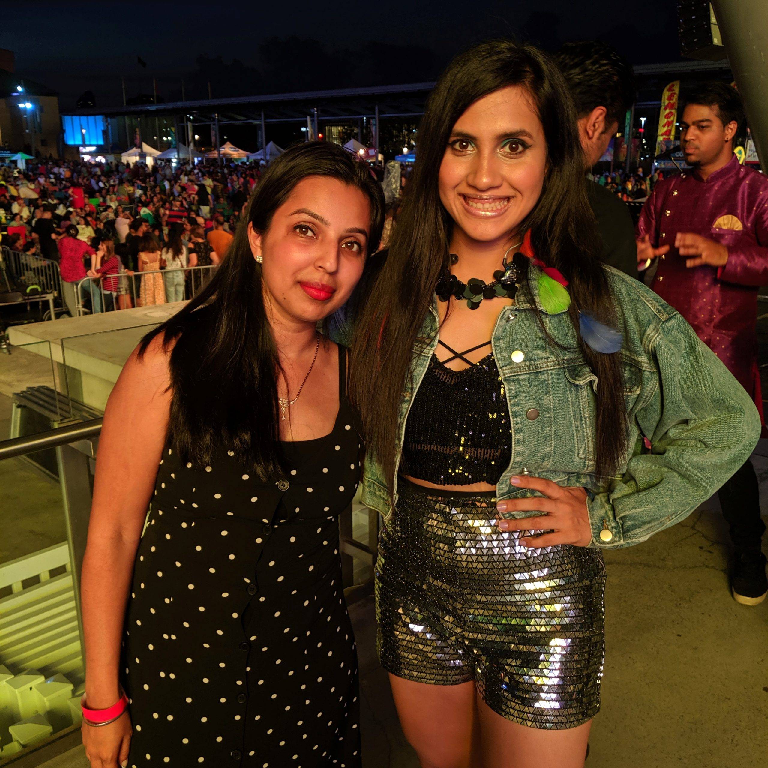Pre-show photo of Creative Director and founder of Dance Expression Studio, Neha with Nikhita Gandhi, Bollywood celebrity singer, poised for a live Bollywood music event.